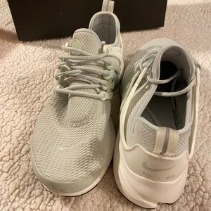 Grey and white Nike prestos